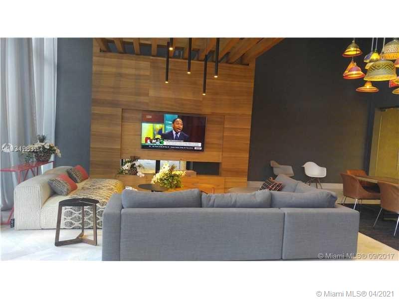 1010 Brickell Avenue, Unit 3204 Miami, FL 33131 - Photo 2 of 32 a living room with furniture and a fireplace