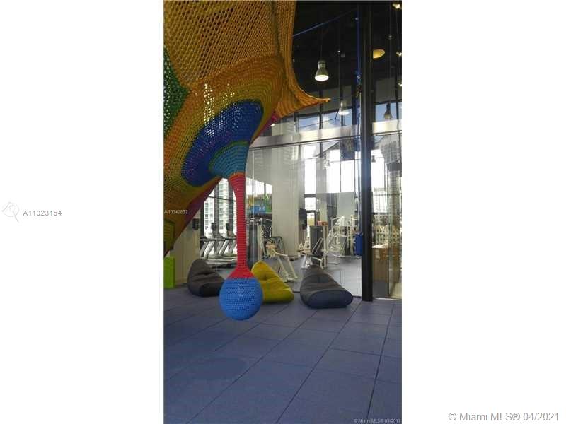 1010 Brickell Avenue, Unit 3204 Miami, FL 33131 - Photo 12 of 32 a hallway with beautiful frames and flower pot