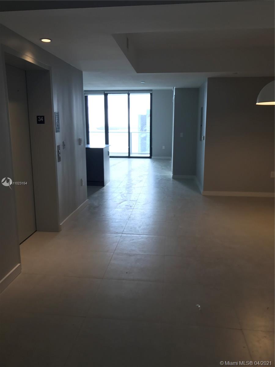 1010 Brickell Avenue, Unit 3204 Miami, FL 33131 - Photo 15 of 32 an empty room with wooden floor and windows