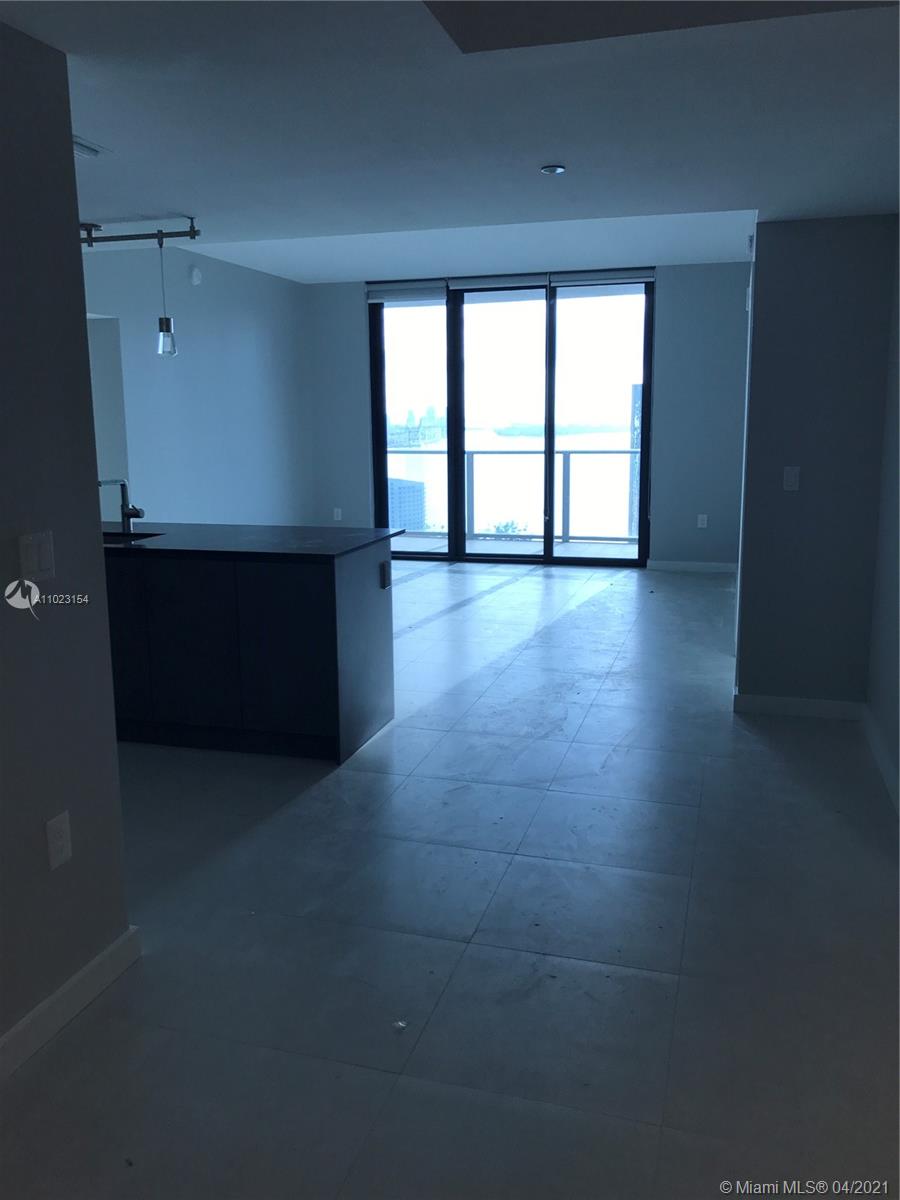 1010 Brickell Avenue, Unit 3204 Miami, FL 33131 - Photo 18 of 32 a view of empty room with wooden floor and fan