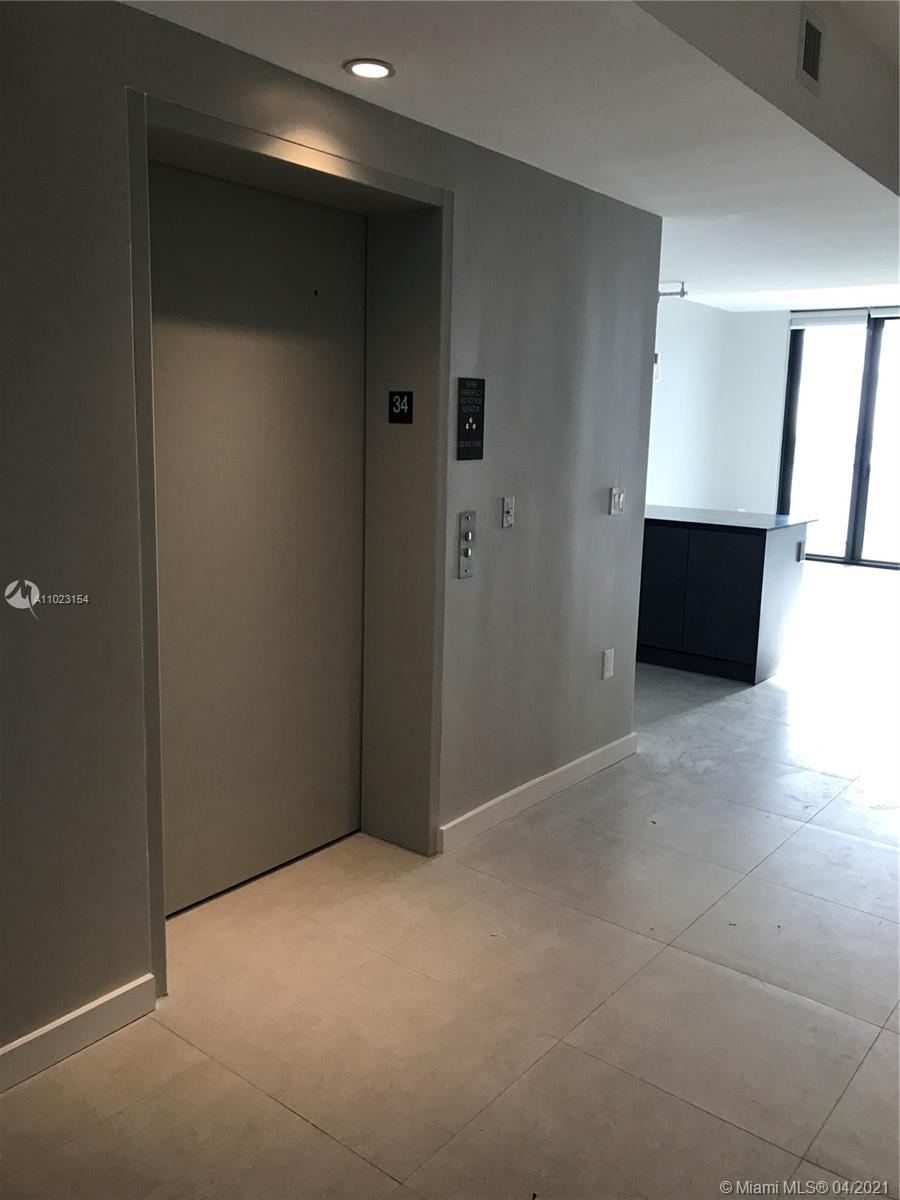 1010 Brickell Avenue, Unit 3204 Miami, FL 33131 - Photo 21 of 32 a view of an empty room with wooden floor