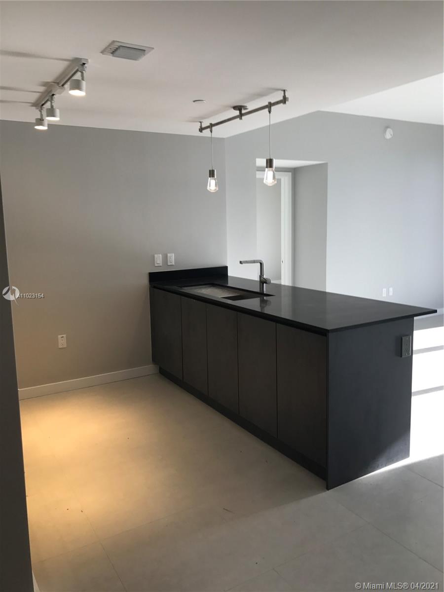 1010 Brickell Avenue, Unit 3204 Miami, FL 33131 - Photo 22 of 32 a kitchen with a sink and cabinets