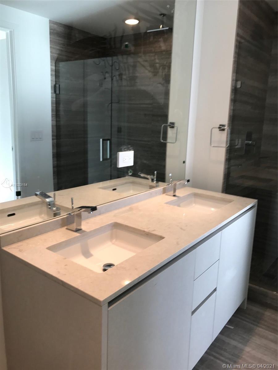1010 Brickell Avenue, Unit 3204 Miami, FL 33131 - Photo 31 of 32 a bathroom with a sink and a mirror