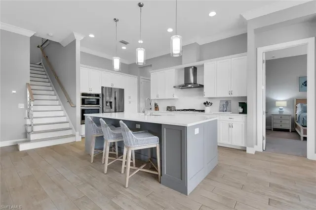 a large kitchen with kitchen island a stove a sink a dining table and chairs