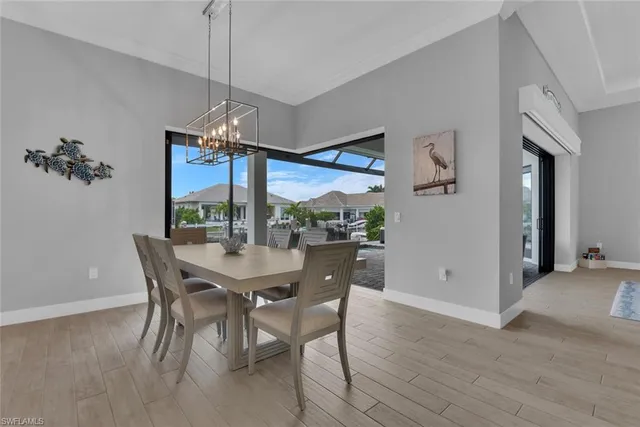 a dining room with furniture and a floor to ceiling window
