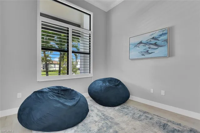 a spacious bedroom with a bed and a flat screen tv