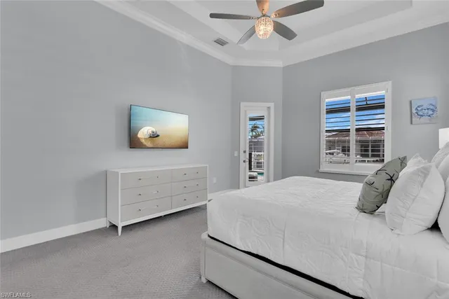 a bedroom with a bed and a ceiling fan