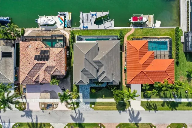 an aerial view of multiple houses with yard