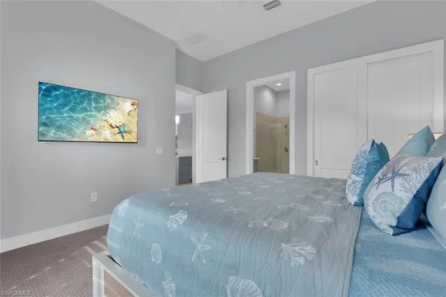 a bathroom with a toilet a sink a mirror and vanity