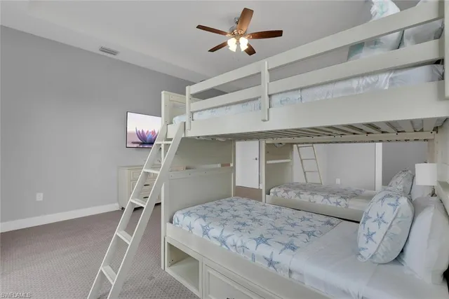 a living room with furniture and a ceiling fan