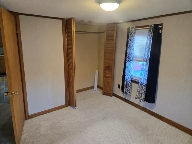 a view of an empty room with brick wall