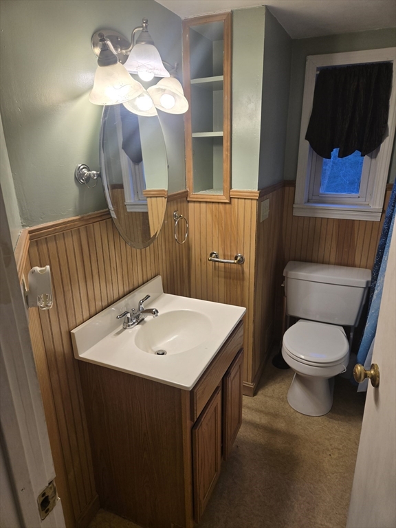 59 Edgehill Road, Unit 2 Taunton, MA 02780 - Photo 6 of 15 a bathroom with a sink a toilet and mirror