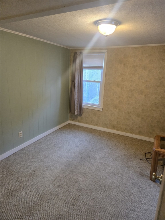 59 Edgehill Road, Unit 2 Taunton, MA 02780 - Photo 8 of 15 an empty room with a chair and a window