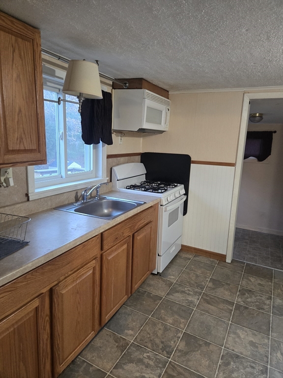 59 Edgehill Road, Unit 2 Taunton, MA 02780 - Photo 9 of 15 a kitchen with a sink appliances and cabinets