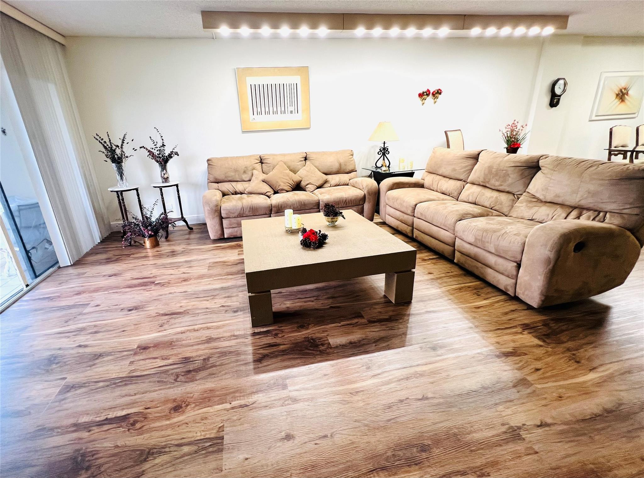 800 Northeast 195th Street, Unit 307 Miami, FL 33179 - Photo 14 of 63 a living room with furniture and a wooden floor