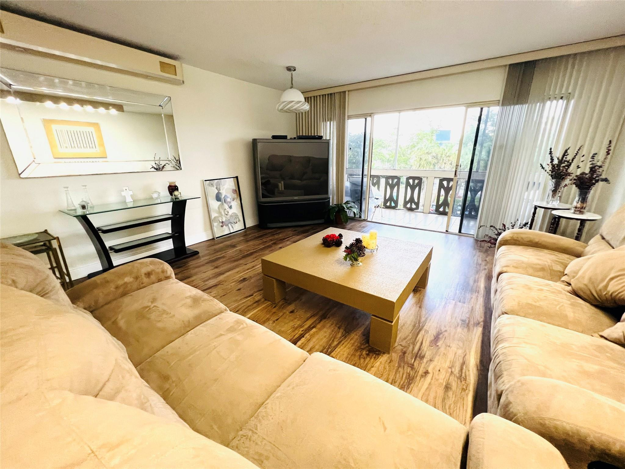 800 Northeast 195th Street, Unit 307 Miami, FL 33179 - Photo 17 of 63 a living room with furniture fireplace and flat screen tv