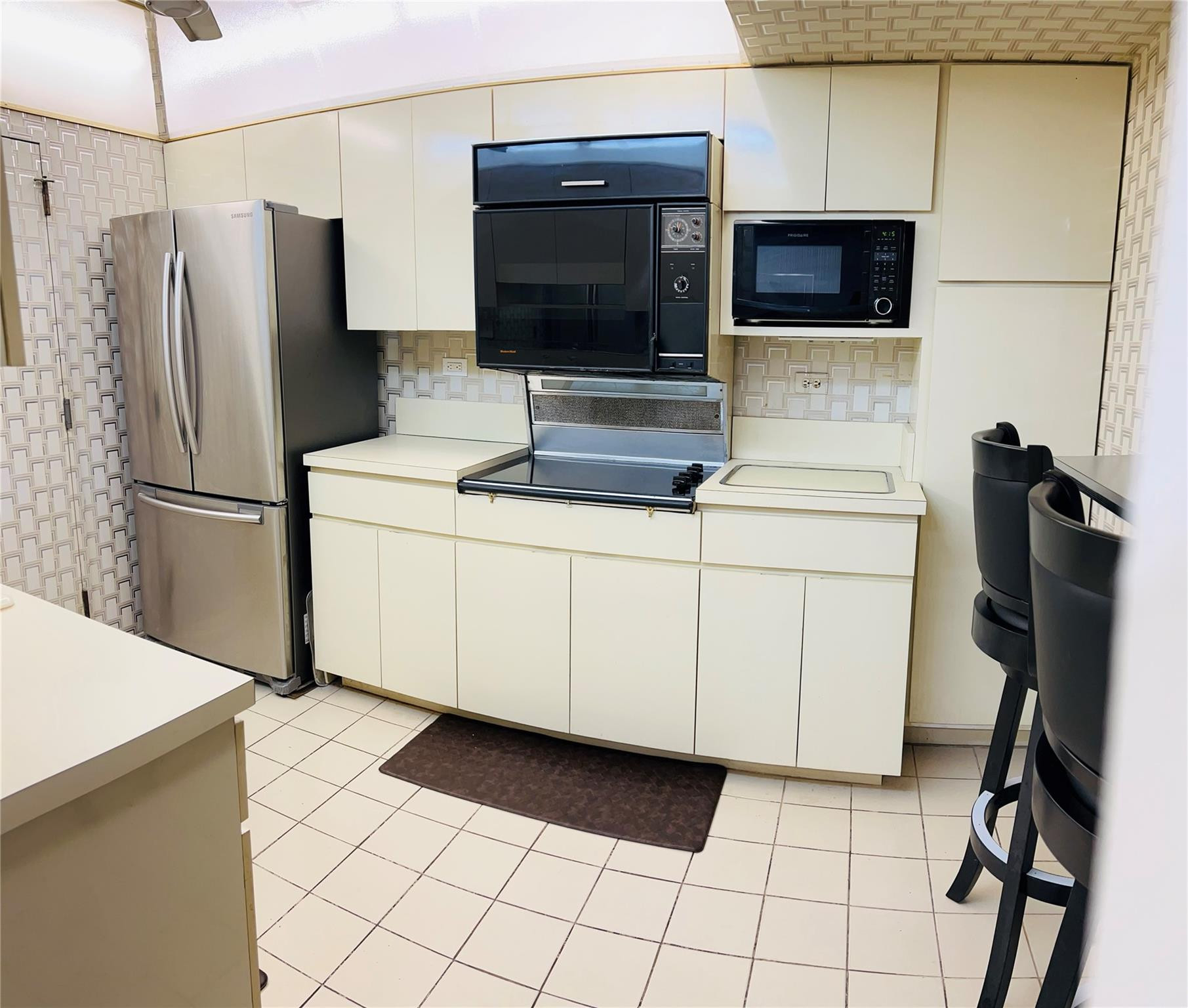 800 Northeast 195th Street, Unit 307 Miami, FL 33179 - Photo 22 of 63 a kitchen with stainless steel appliances a refrigerator a stove a microwave and a sink