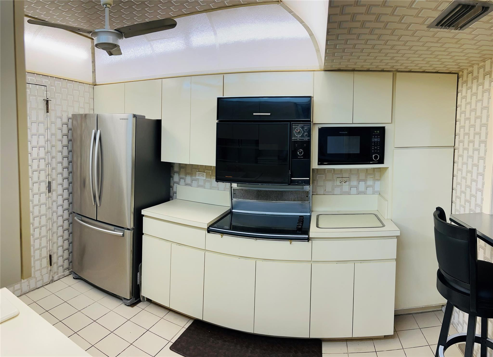 800 Northeast 195th Street, Unit 307 Miami, FL 33179 - Photo 23 of 63 a kitchen with stainless steel appliances white cabinets and a refrigerator
