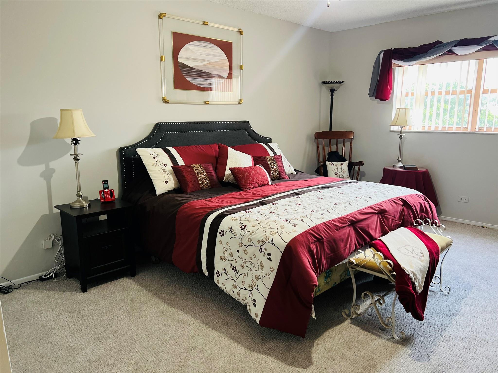 800 Northeast 195th Street, Unit 307 Miami, FL 33179 - Photo 29 of 63 a bedroom with a bed and a lamp on dresser