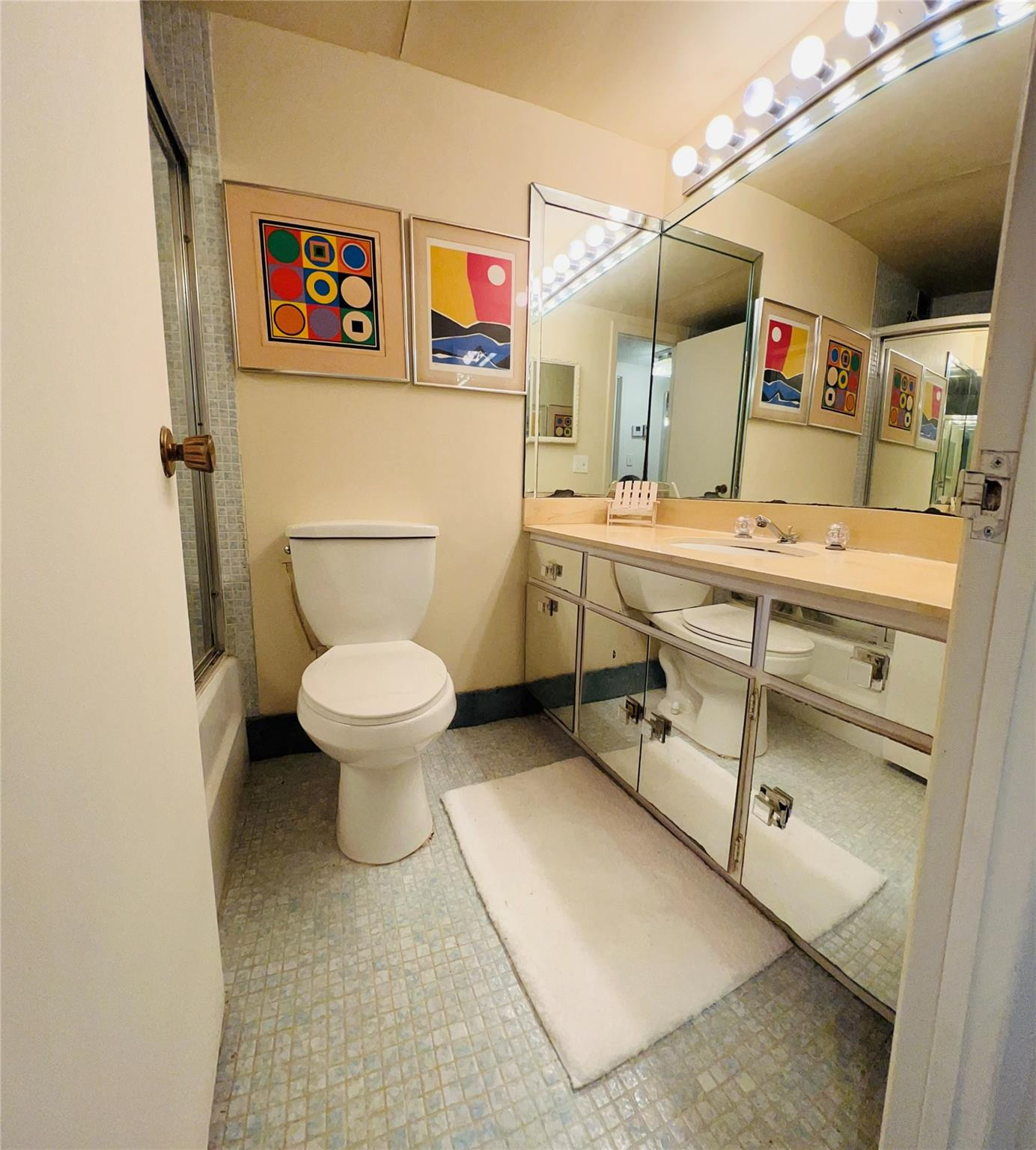 800 Northeast 195th Street, Unit 307 Miami, FL 33179 - Photo 52 of 63 a bathroom with a sink a toilet and a mirror