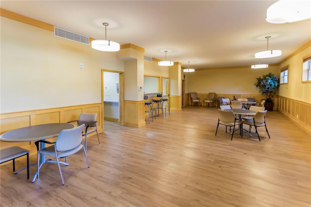800 Northeast 195th Street, Unit 307 Miami, FL 33179 - Photo 53 of 63 a dining room with furniture and wooden floor