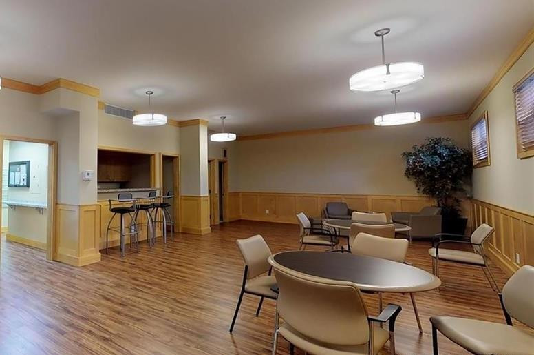 800 Northeast 195th Street, Unit 307 Miami, FL 33179 - Photo 55 of 63 a dining room with furniture a chandelier and wooden floor