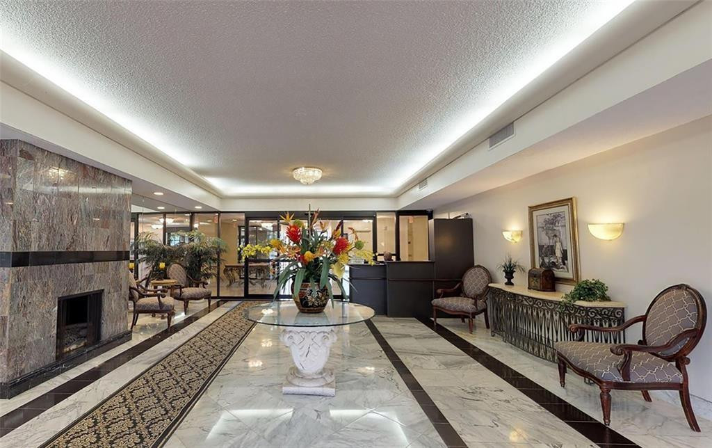 800 Northeast 195th Street, Unit 307 Miami, FL 33179 - Photo 6 of 63 a living room with furniture and a fireplace