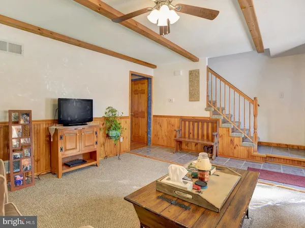 a living room with furniture and flat screen tv