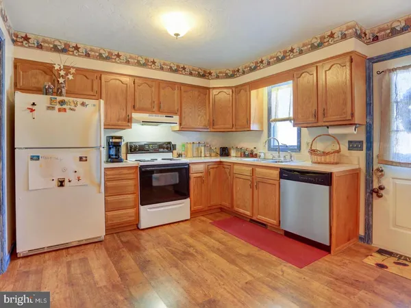 a kitchen with stainless steel appliances a refrigerator sink and cabinets