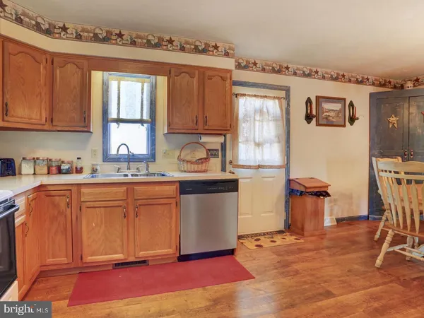 a kitchen with stainless steel appliances granite countertop a refrigerator sink and cabinets