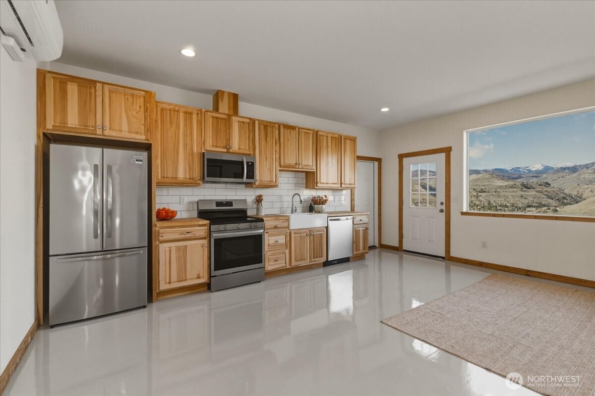 2 Island View Lane Methow, WA 98834 - Photo 17 of 35 a kitchen with stainless steel appliances granite countertop a refrigerator stove top oven a sink and dishwasher