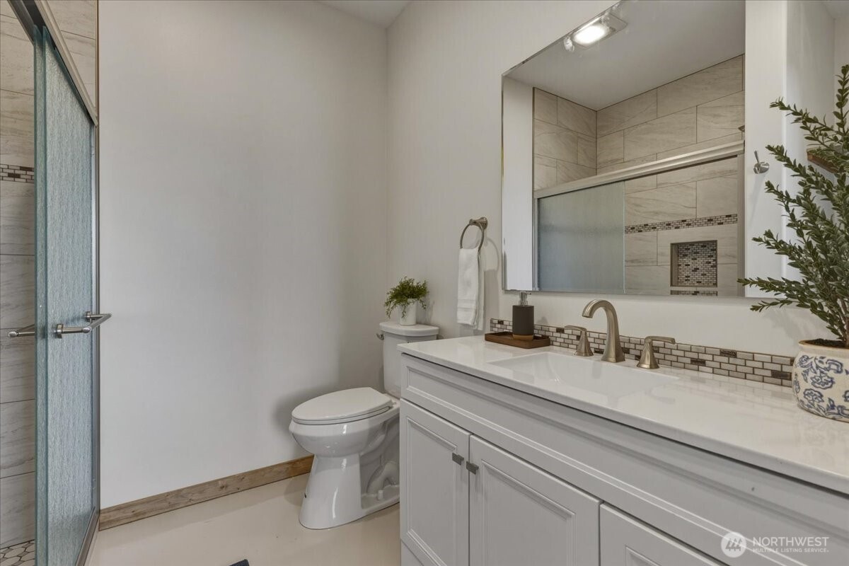 2 Island View Lane Methow, WA 98834 - Photo 24 of 35 a bathroom with a granite countertop sink a toilet and a mirror