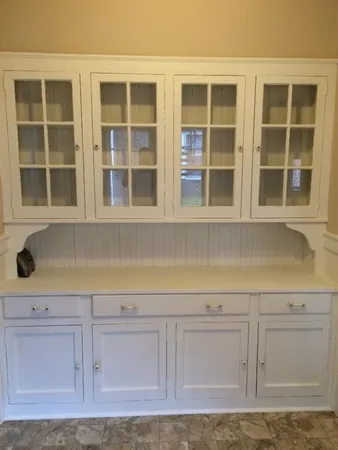 a view of granite countertop white cabinets and a sink