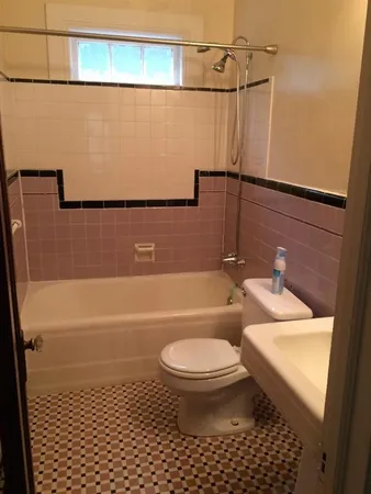 a bathroom with a toilet a sink and bathtub