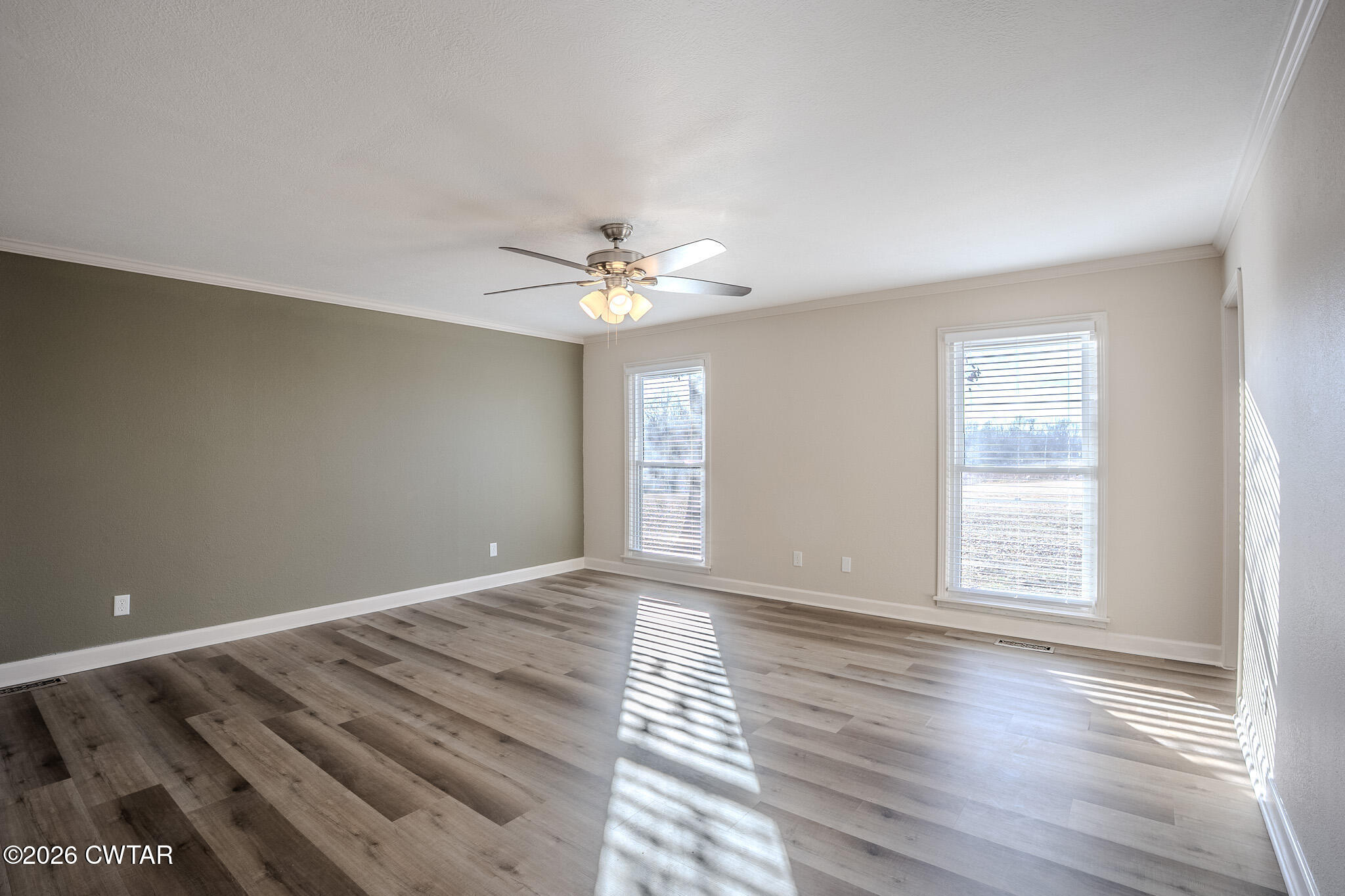 2467 Windrow Road Brownsville, TN 38012 - Photo 15 of 32 a view of an empty room with wooden floor and a window