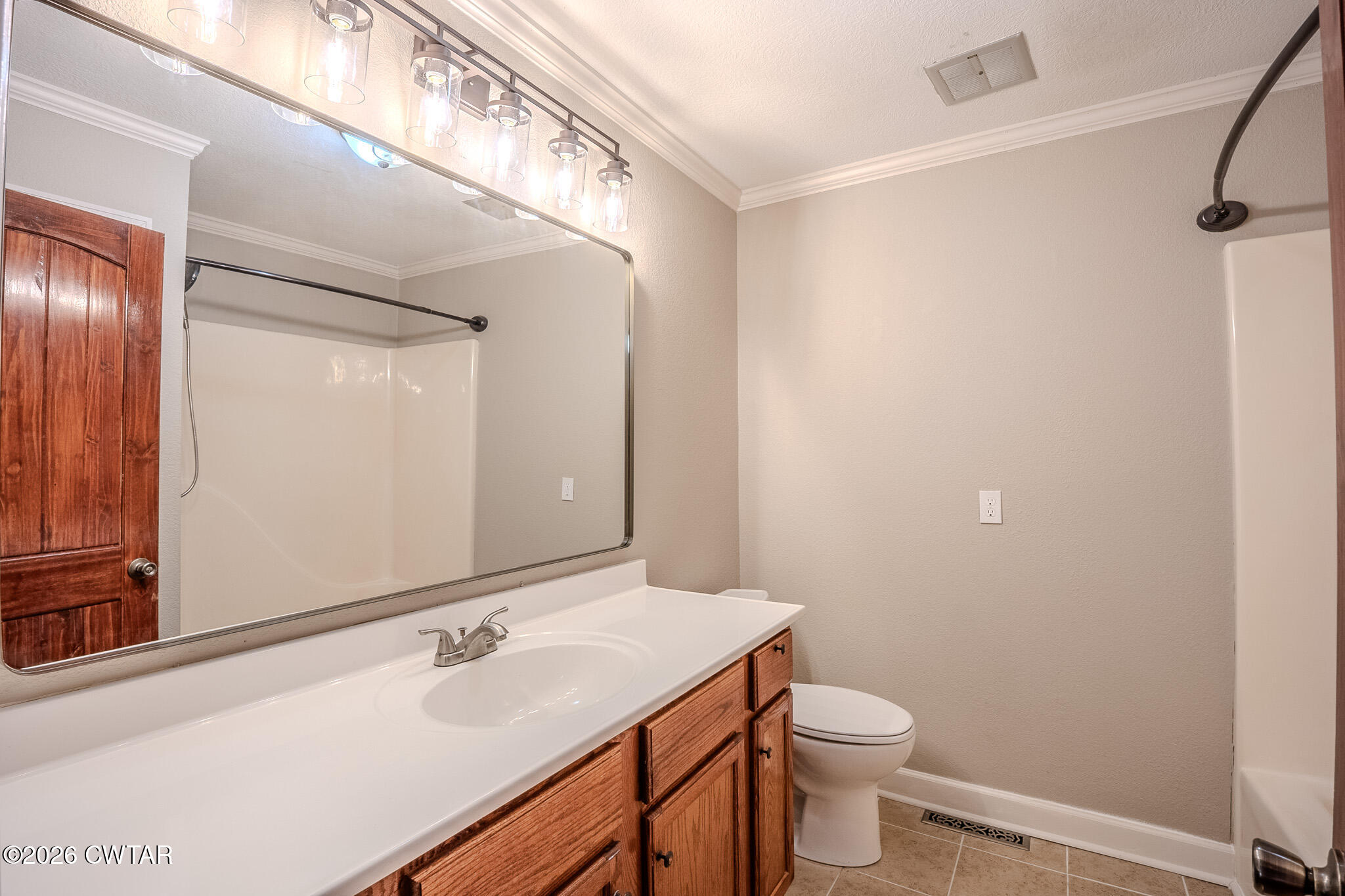 2467 Windrow Road Brownsville, TN 38012 - Photo 21 of 32 a bathroom with a sink a toilet and a mirror