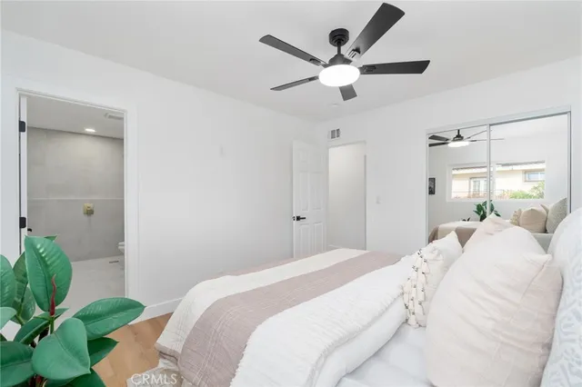 a bedroom with a large bed and a chandelier