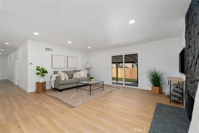 a living room with furniture and a potted plant