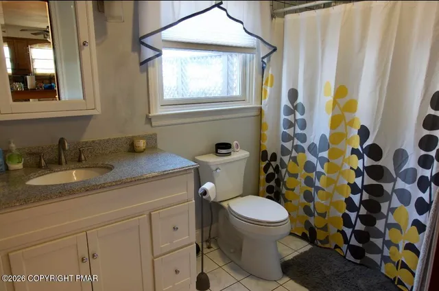 a bedroom with a bed and a night stand