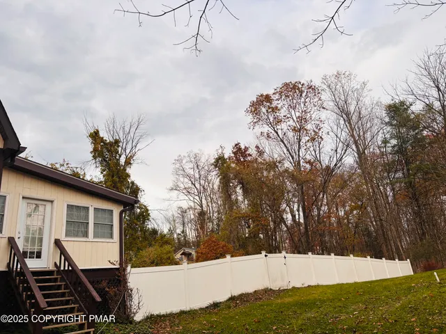 a view of a roof deck with wooden floor and fence