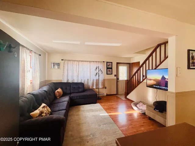 a kitchen with stainless steel appliances granite countertop a refrigerator a sink a stove and a refrigerator