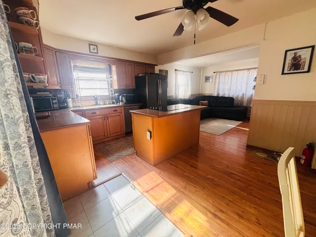 a kitchen with a refrigerator a stove top oven a sink and dishwasher