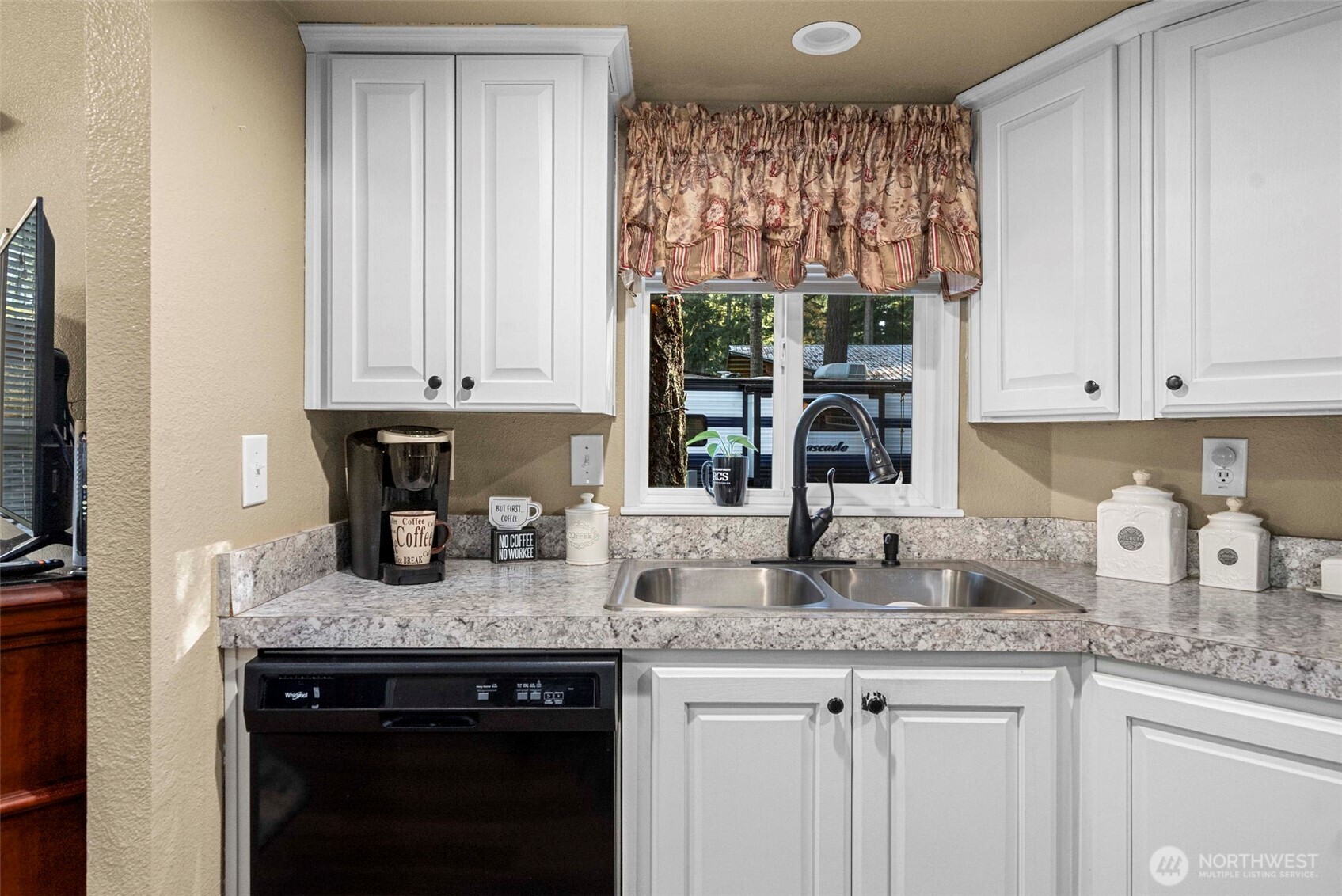 1546 Reservation Road Southeast, Unit 218 Olympia, WA 98513 - Photo 8 of 40 a kitchen with granite countertop a sink a stove and cabinets