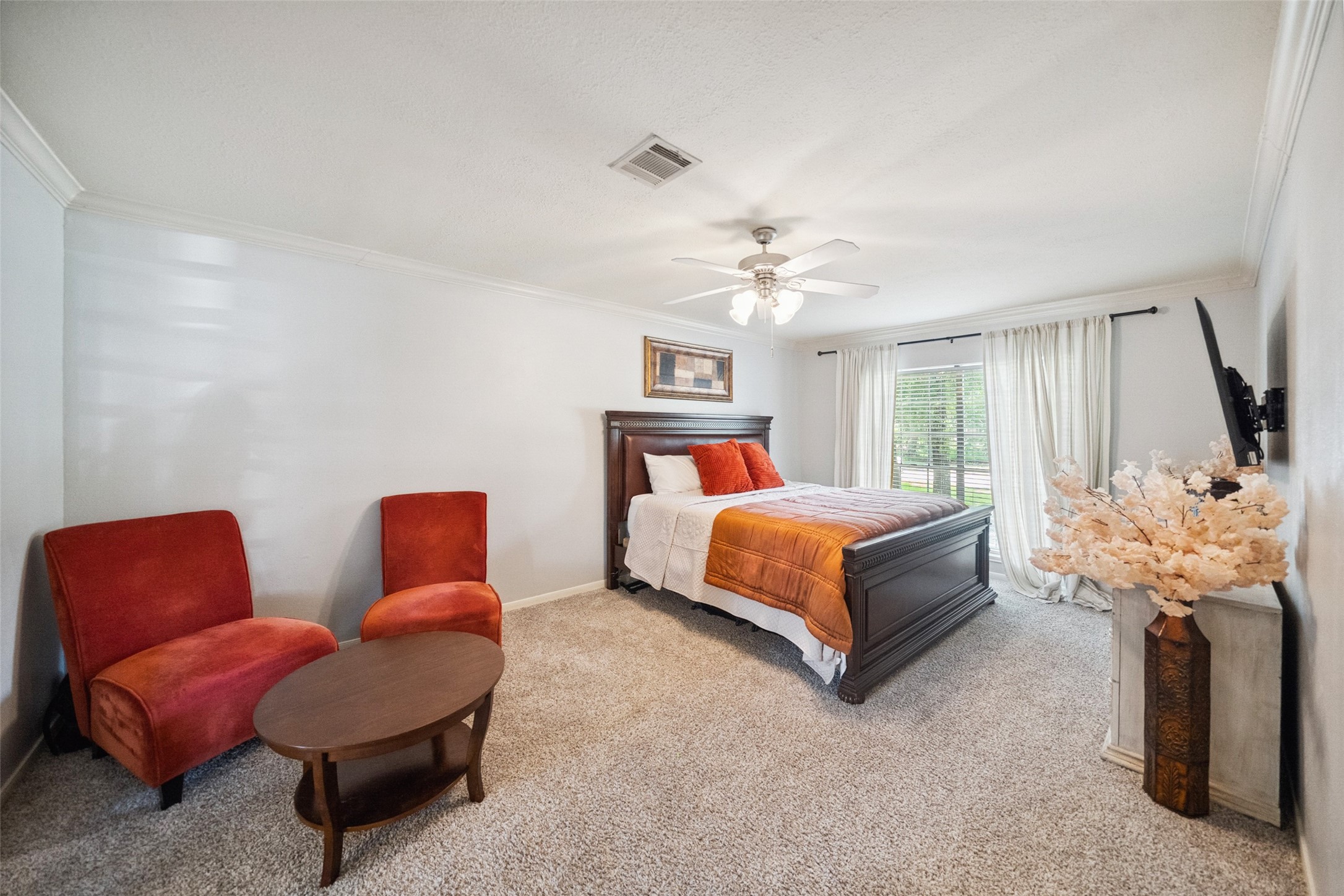 20407 Weald Way Street Spring, TX 77388 - Photo 16 of 31 a bedroom with a bed couch and chandelier