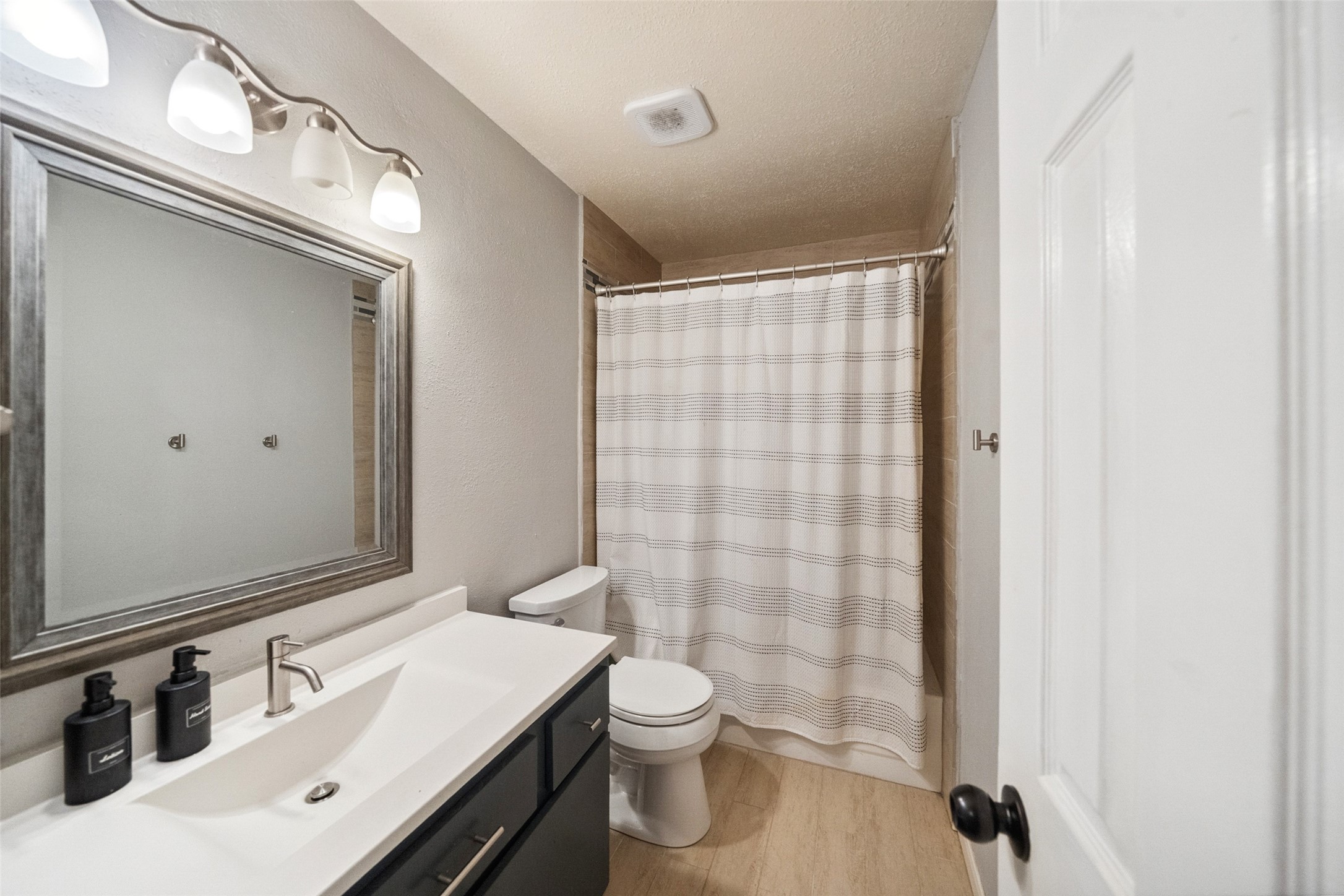 20407 Weald Way Street Spring, TX 77388 - Photo 27 of 31 a bathroom with a sink a toilet and shower