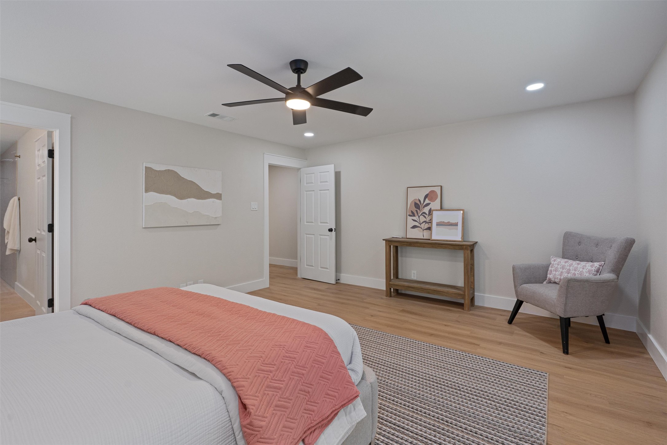 224 Clear Spring Road Georgetown, TX 78628 - Photo 22 of 40 a bedroom with a bed and a chandelier