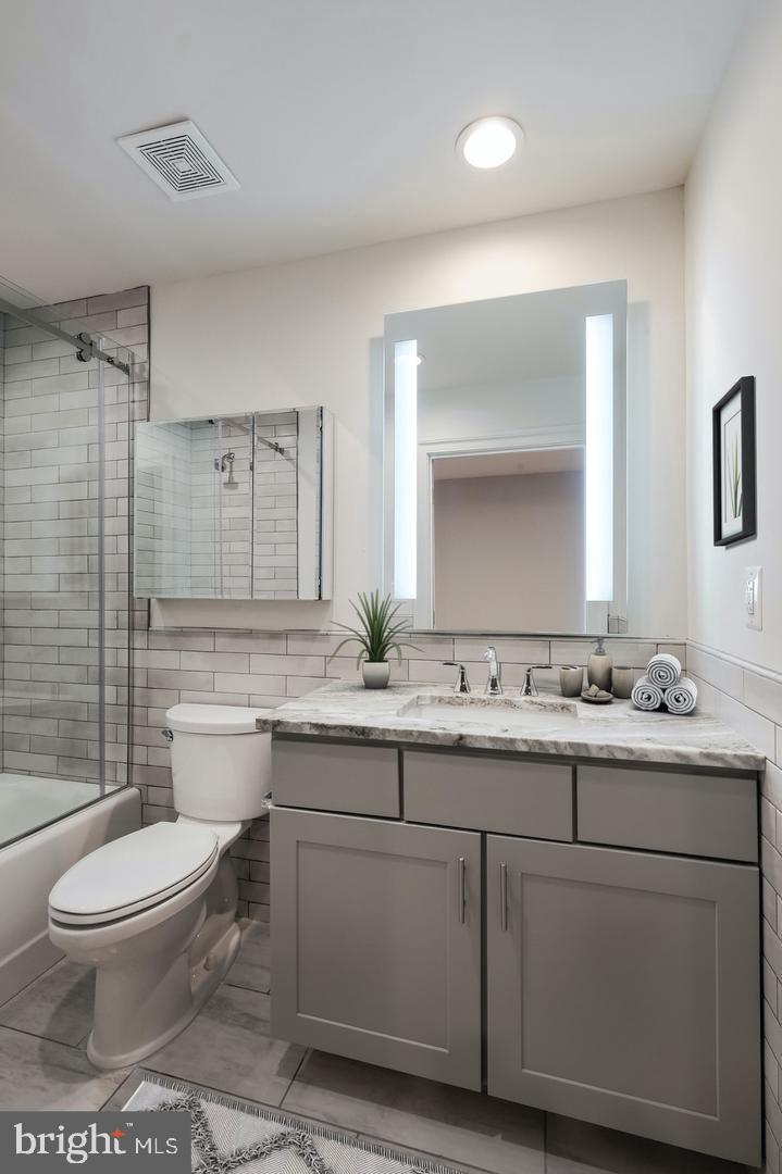 60 North 23rd Street, Unit 2013 Philadelphia, PA 19103 - Photo 8 of 46 a bathroom with a toilet sink and mirror