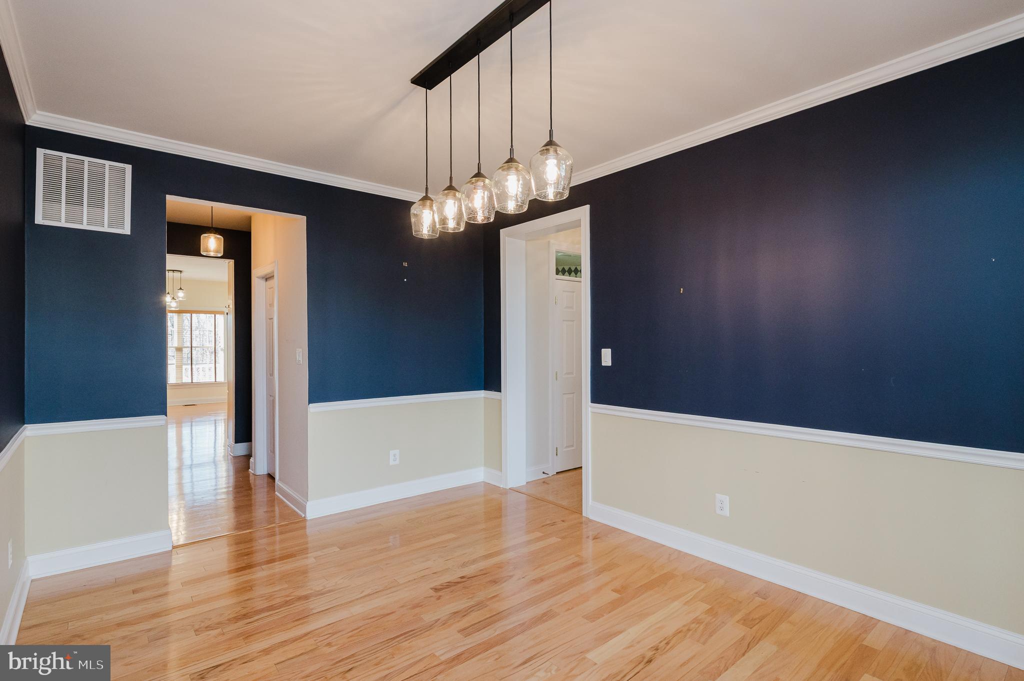 130 Fallston Meadow Court Fallston, MD 21047 - Photo 19 of 80 a view of an empty room with wooden floor and a chandelier