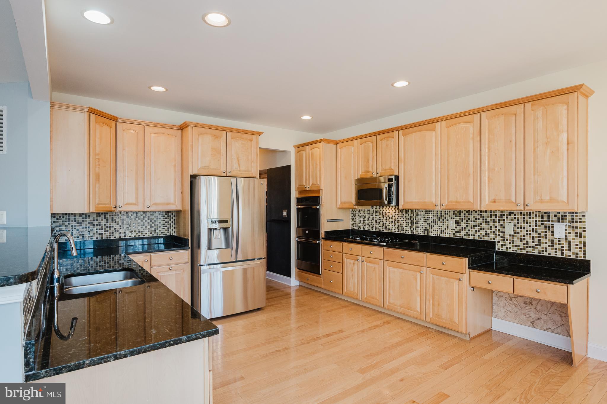 130 Fallston Meadow Court Fallston, MD 21047 - Photo 23 of 80 a kitchen with stainless steel appliances granite countertop a refrigerator a stove and a sink