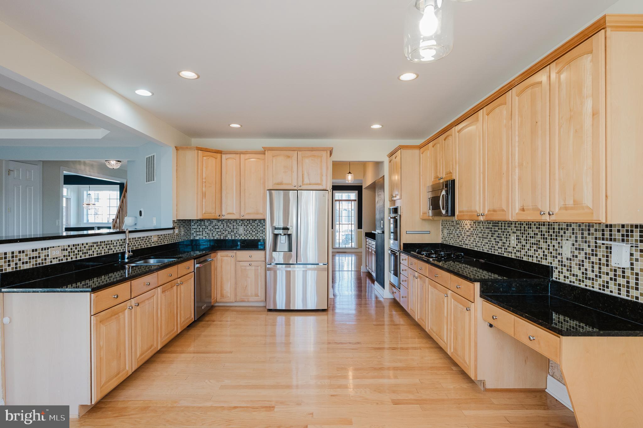 130 Fallston Meadow Court Fallston, MD 21047 - Photo 24 of 80 a kitchen with stainless steel appliances granite countertop a stove a sink and a refrigerator